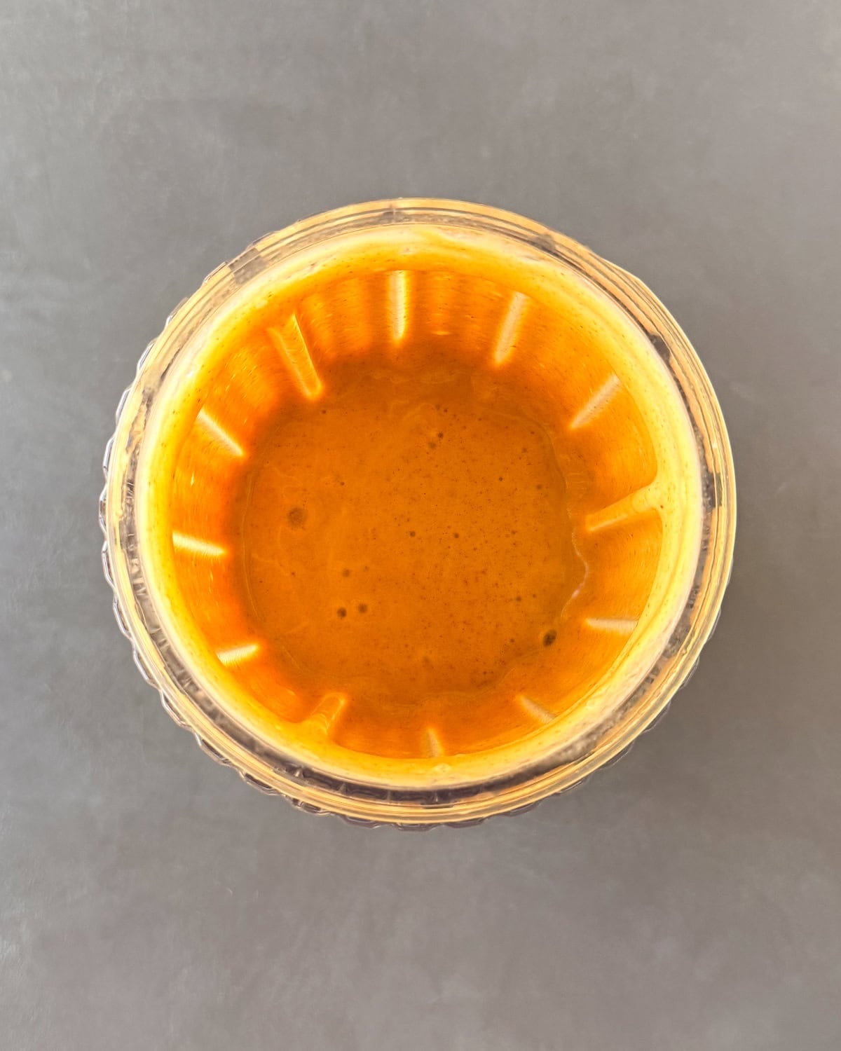 Pumpkin pie protein shake purée in a blender cup.