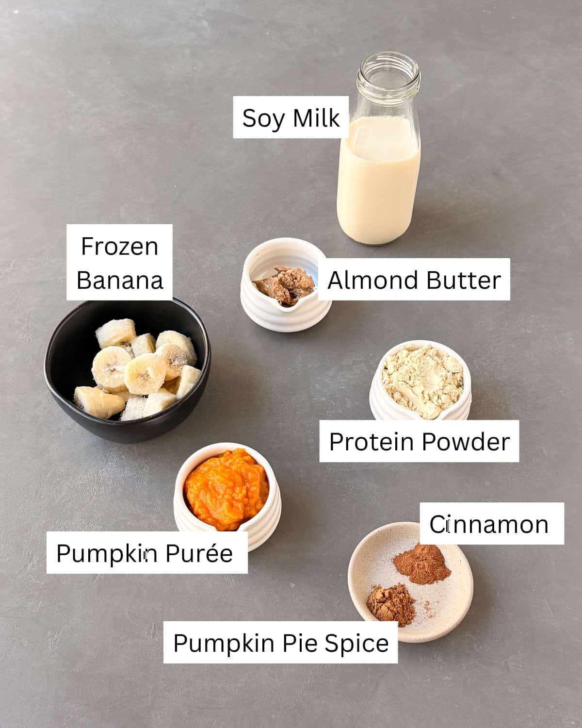 Pumpkin pie smoothie ingredients laid out separately with labels.