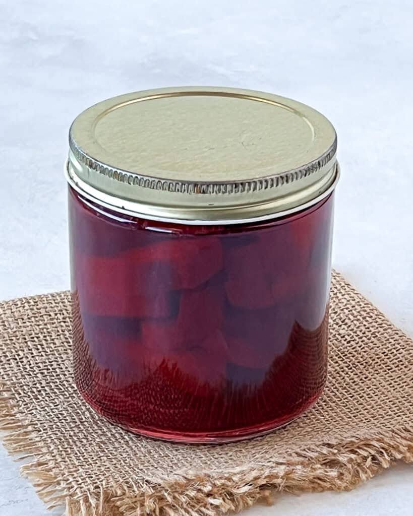 Pickled beets in a sealed glass jar.