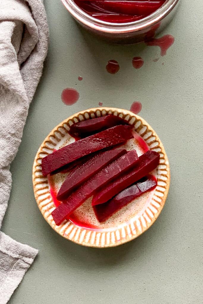 Pickled beets in a small serving bowl.