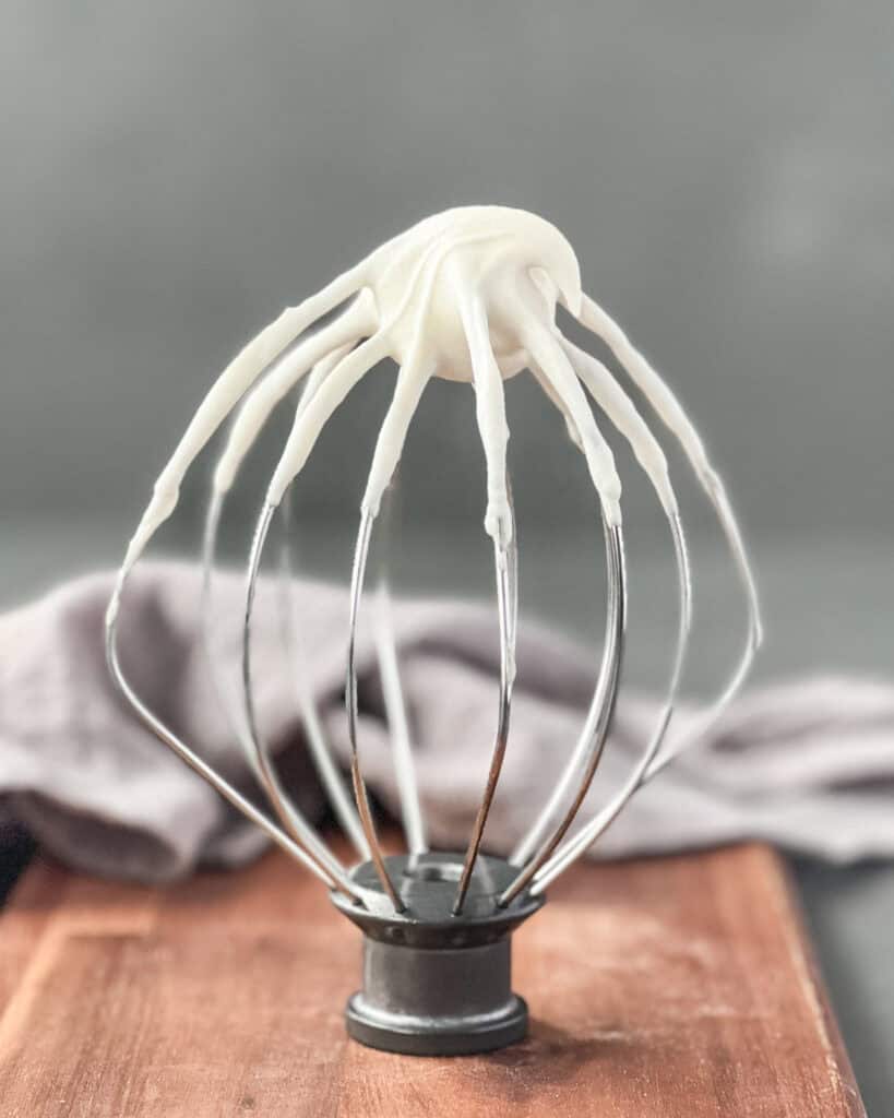 A whisk tip covered with oat milk whipped cream. 