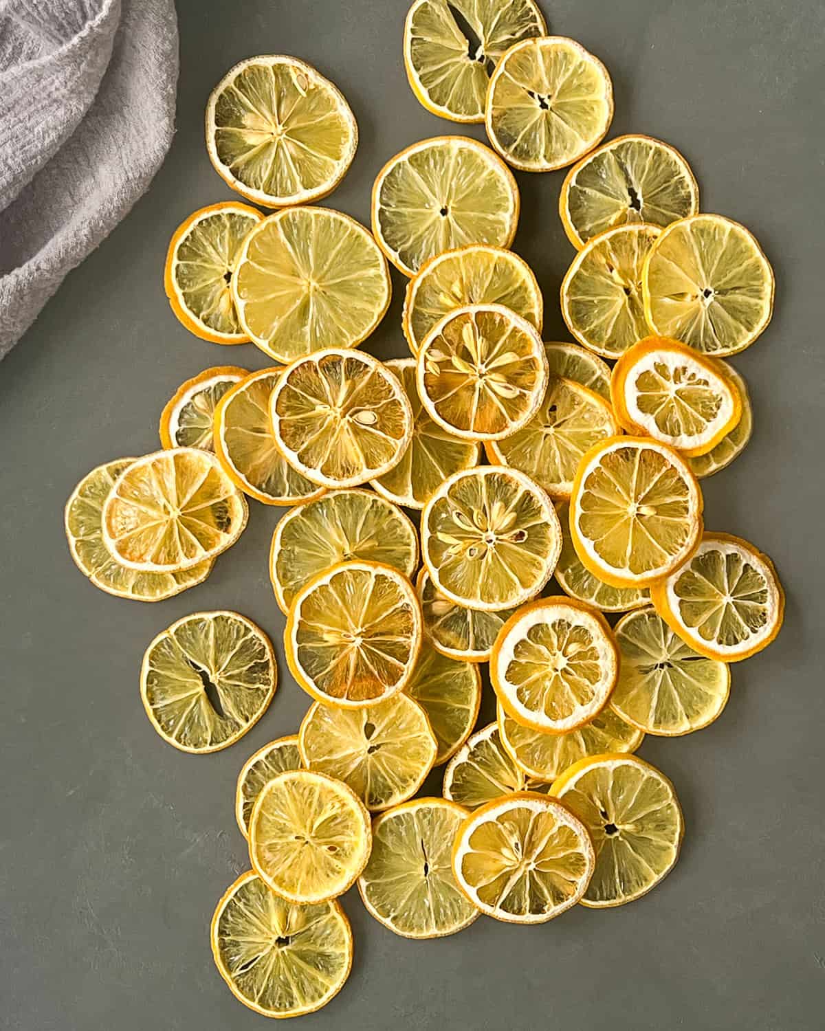 Dehydrated lemon slices bunched together on a flat surface.